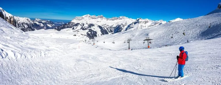 Beautiful winter landscape with Swiss Alps. Skiers skiing in famous Engelgerg - Titlis ski resort, Switzerland, Europe