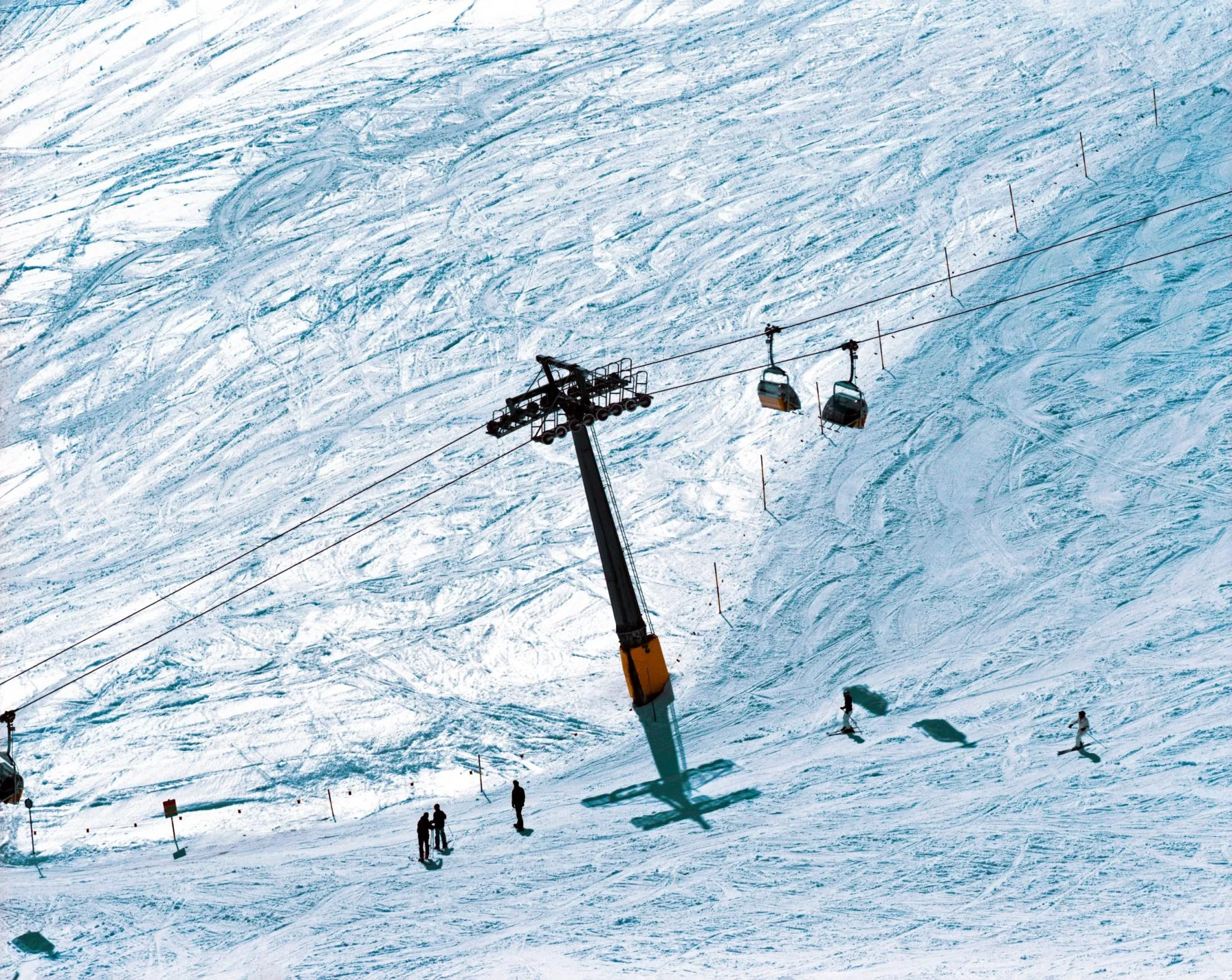 A ski piste and people ski in the snowscape of the alps in St Moritz Switzerland