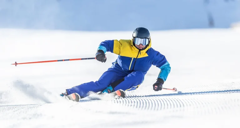 A young aggressive skier on an alpine slope demonstrates an extreme carving skiing style.
